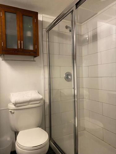 a bathroom with a toilet and a glass shower at Condo in Downtown in Vancouver