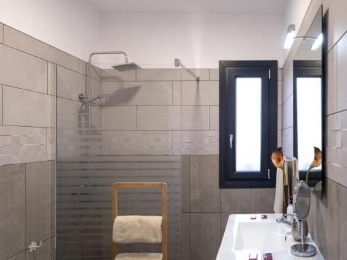 a bathroom with a shower and a sink and a sink at Villa La Graja by Huskalia - private pool in Los Llanos de Aridane
