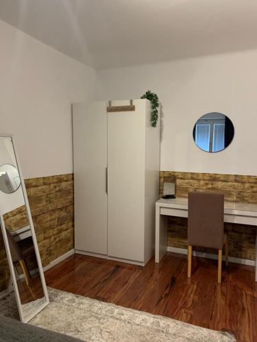 a room with a refrigerator and a desk with a mirror at Comfort Humboldt Apartment in Vienna