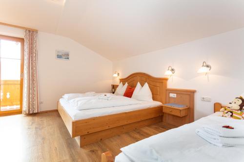 a bedroom with two beds and a teddy bear on the bed at Klockergut in Sankt Veit im Pongau