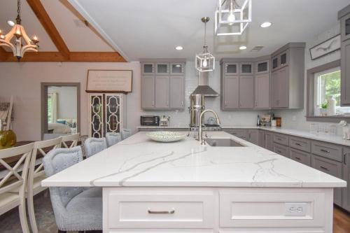 a kitchen with a white counter top and a sink at Mallard Cove Sunsets Lake Martin in Dadeville