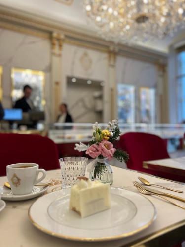 a table with a plate of cheese and a cup of coffee at Touchlux apartments in Cannes