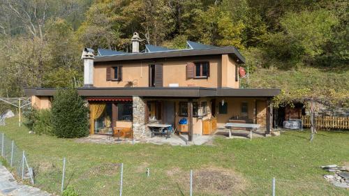 a house that is sitting on top of a field at Casa Bubeck in Cavagnago