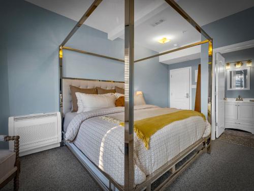 a bedroom with a large bed with a metal frame at The Savannah, Boutique BNB & Spa in Lewes