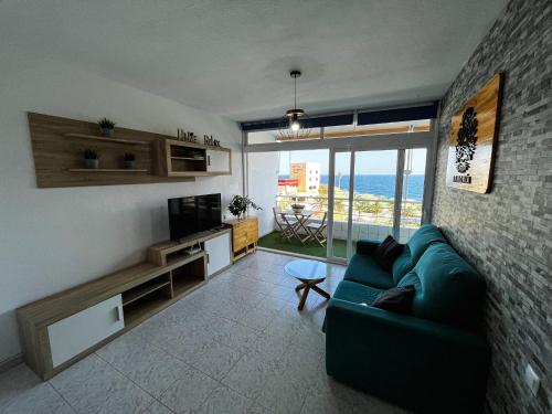 a living room with a couch and a view of the ocean at Apartamento Armonía in Candelaria