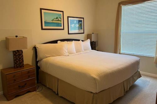 a bedroom with a large bed and a window at 4114 Viz Cay in Orlando