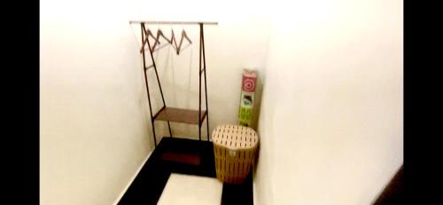 a corner of a room with a shelf and a basket at Accra Luxury Apartments At The Sanga Estates in Accra