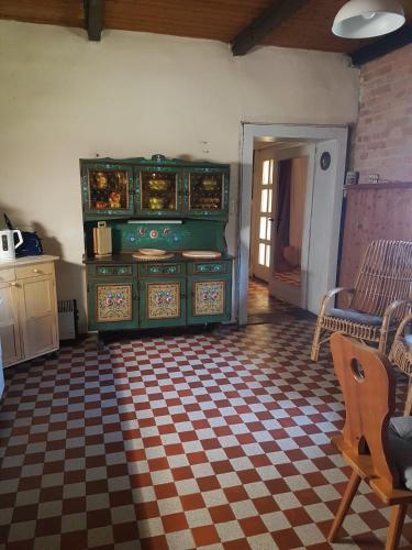 a living room with a dresser and a checkered floor at Ferienwohnung Festhof Nirgendwo in Langewahl