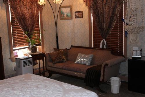 a living room with a couch and a bed at Carriage Stop Bed & Breakfast in Palmyra