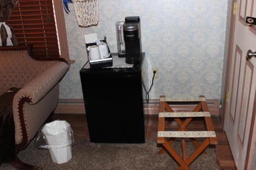 a small black refrigerator with a coffee maker on it at Carriage Stop Bed & Breakfast in Palmyra