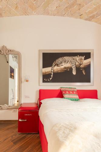 a bedroom with a bed and a painting of a leopard on a branch at Bretone XI b&b in Rome