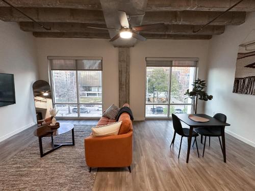 a living room with a couch and a table at The Best of Downtown Living in Baton Rouge