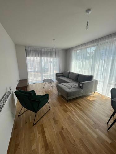 a living room with a couch and a table and chairs at VG Apartments 2 Bedroom LDN in London