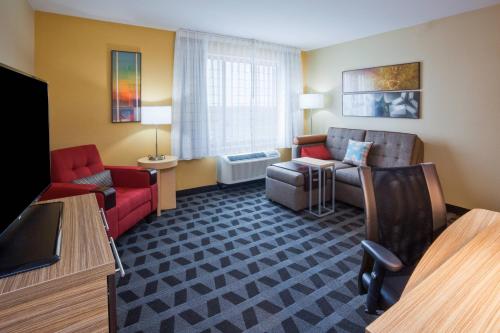 a living room with a couch and a chair at TownePlace Suites by Marriott Sioux Falls South in Sioux Falls