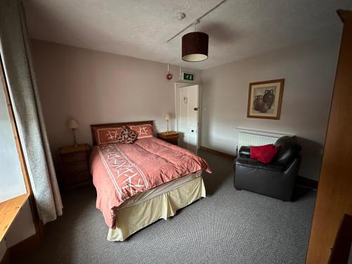 een slaapkamer met een bed en een stoel bij Central Lisburn Accommodation in Lisburn