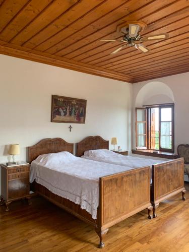 a bedroom with a large bed with a wooden ceiling at House in Propan in Kalamaki