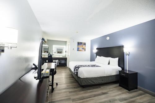 a hotel room with a bed and a camera at La Quinta Inn by Wyndham Tampa Near Busch Gardens in Tampa