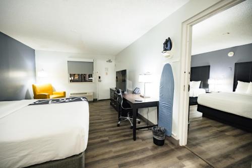 a hotel room with a bed and a desk at La Quinta Inn by Wyndham Tampa Near Busch Gardens in Tampa