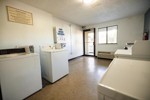 a kitchen with white appliances in a room at La Quinta Inn by Wyndham Tampa Near Busch Gardens in Tampa