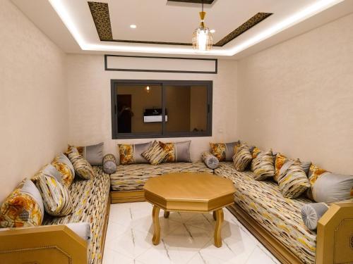 a living room with a large couch with pillows at les Belles Résidences de Safir in Tangier
