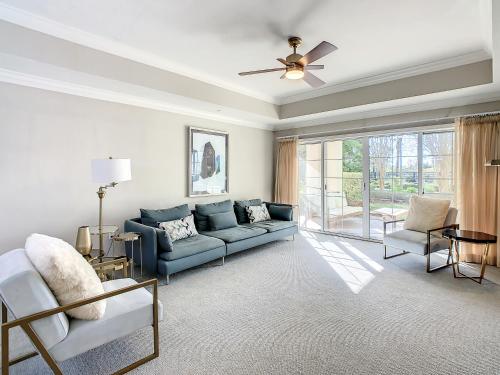 a living room with a couch and a ceiling fan at MINUTES FROM DISNEY 3bed 3bath Poolside at LUXURIOUS RESORT in Kissimmee