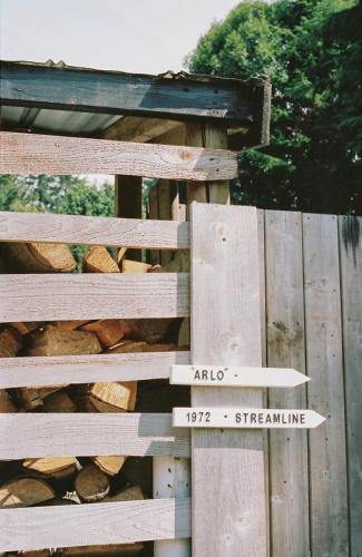 a wooden fence with a sign on it at Dreamy Airstream Hideaway with Hot Tub in Gibsons