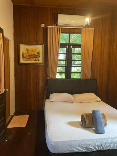 a bedroom with a large bed with a window at Rumah Seraya@Zaki’s Residence, Marang, Terengganu in Marang