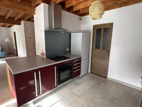 a kitchen with a counter and a stove top oven at La Maison Verte in Clécy