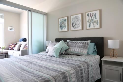 a bedroom with a bed with a blue and white comforter at Queen Anne Retreat - 1 Blk from CPA - Free Parking in Seattle