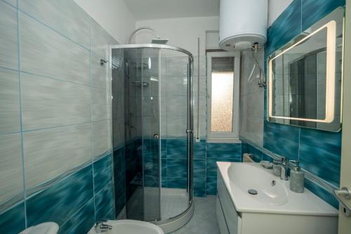 y baño con ducha, aseo y lavamanos. en Appartamento Hakuna Matata, en Shkodër