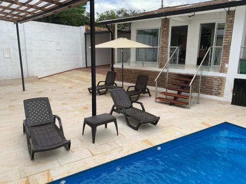 a patio with chairs and a swimming pool at Hermosa Casa Central - Rositas's house in La Mesa
