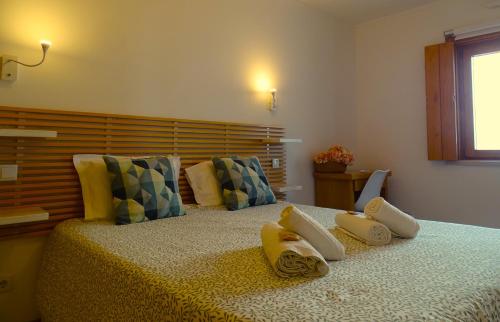 A bed or beds in a room at SWEET HOME MILFONTES by Stay in Alentejo