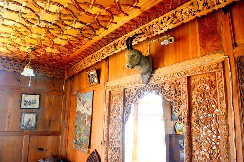 a stuffed animal hanging on the wall of a room at Kings Houseboats in Srinagar