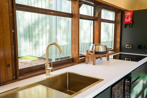 a kitchen with a sink and a window at BIG4 Yarra Valley Park Lane Holiday Park in Healesville