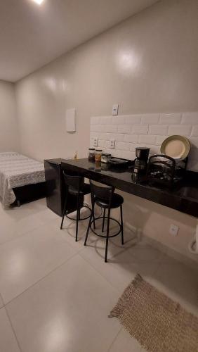 a living room with a table and two chairs at Morada do Sol Suítes in Arraial do Cabo