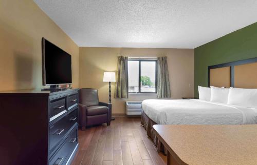 a hotel room with two beds and a flat screen tv at Extended Stay America Suites - Knoxville - West Hills in Knoxville