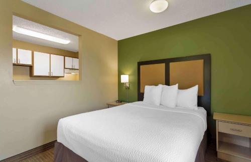 a large bed in a room with green walls at Extended Stay America Suites - Knoxville - West Hills in Knoxville
