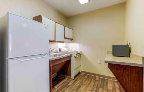 a small kitchen with a refrigerator and a sink at Extended Stay America Suites - Knoxville - West Hills in Knoxville