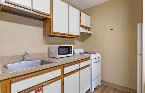 a small kitchen with a sink and a microwave at Extended Stay America Suites - Knoxville - West Hills in Knoxville