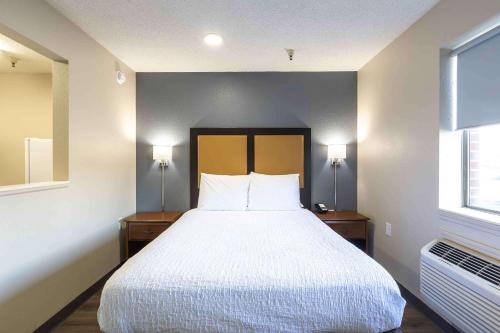a bedroom with a large bed with two nightstands and two lamps at Extended Stay America Suites - Columbia - Greystone in Columbia