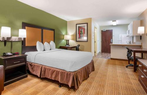 a hotel room with a large bed and a kitchen at Extended Stay America Suites - Cincinnati - Florence - Turfway Rd in Florence