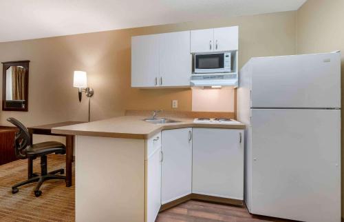 a kitchen with a white refrigerator and a microwave at Extended Stay America Suites - Cincinnati - Florence - Turfway Rd in Florence