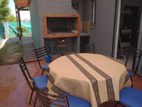a table and chairs on a patio with a fireplace at Casa de Funes city in Funes