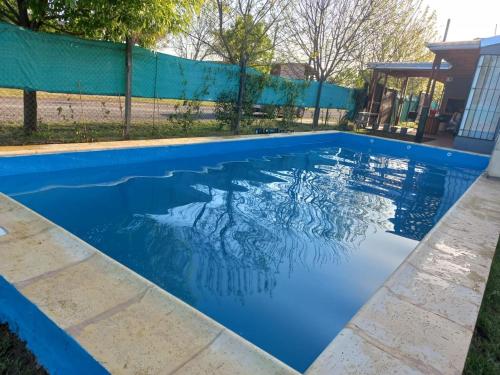 a swimming pool with blue water in a yard at Casa de Funes city in Funes