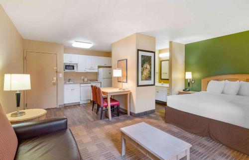 a hotel room with a bed and a kitchen at Extended Stay America Suites - Orlando - Lake Buena Vista in Orlando