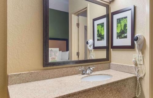 a bathroom sink with a mirror and a hair dryer at Extended Stay America Suites - Atlanta - Gwinnett Place in Duluth