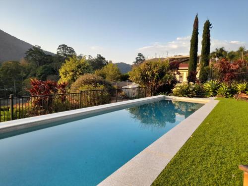 a swimming pool in the yard of a house at A view of Mount Warning in Uki