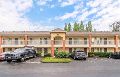 a hotel with cars parked in a parking lot at Extended Stay America Suites - Portland - Tigard in Tigard