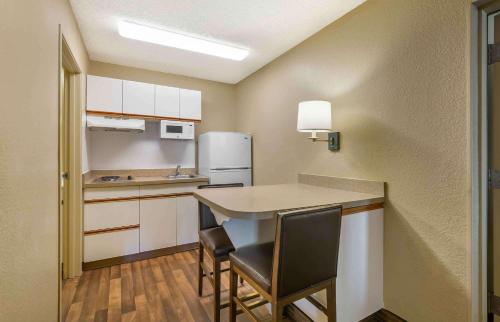 a small kitchen with a table and chairs at Extended Stay America Suites - Portland - Tigard in Tigard