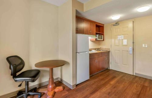 a small kitchen with a table and a refrigerator at Extended Stay America Suites - Chesapeake - Greenbrier Circle in Chesapeake